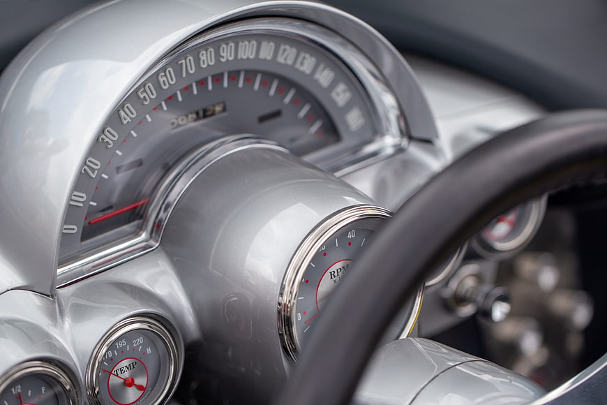 Close-up of vintage car dashboard with speedometer and gauges