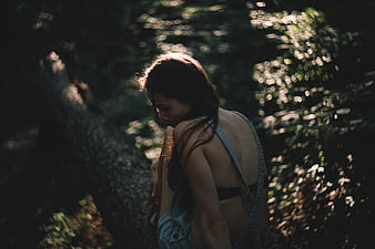 Woman in Denim Overalls in Sunlit Forest