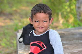 Portrait of a smiling young boy in a superhero shirt