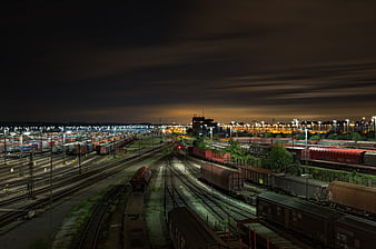 Night view of a large railway marshalling yard with freight trains