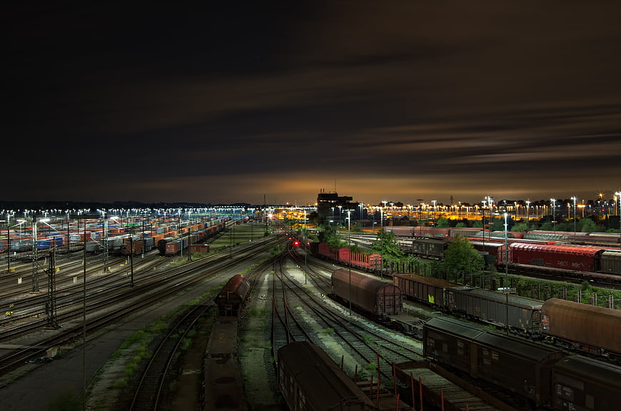 Night view of a large railway marshalling yard with freight trains