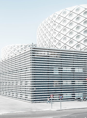 Modern white architecture with geometric patterns and parking garage