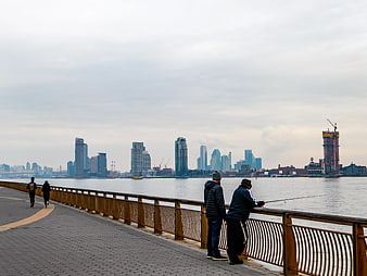 People Fishing and Walking on Brooklyn Waterfront Promenade