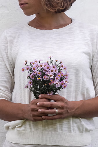 Woman Holding Small Bouquet of Purple Aster Flowers
