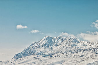 Snow-Capped Mountain Peak Against Blue Sky