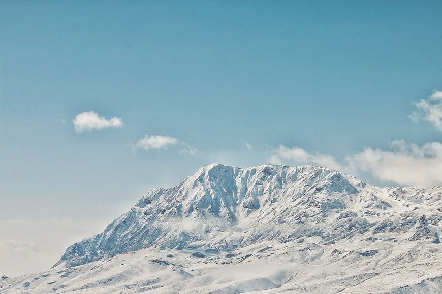 Snow-Capped Mountain Peak Against Blue Sky