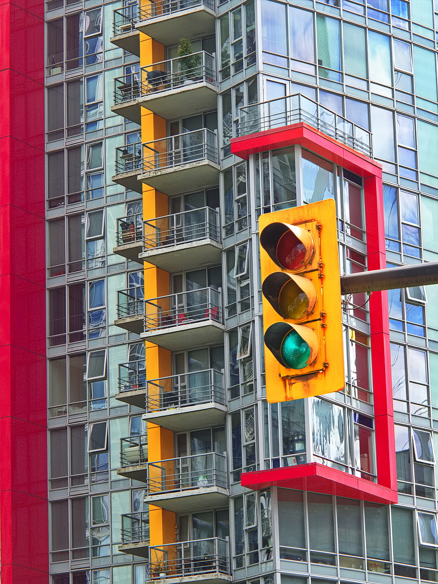 Colorful Urban Traffic Light Against Modern Apartment Building