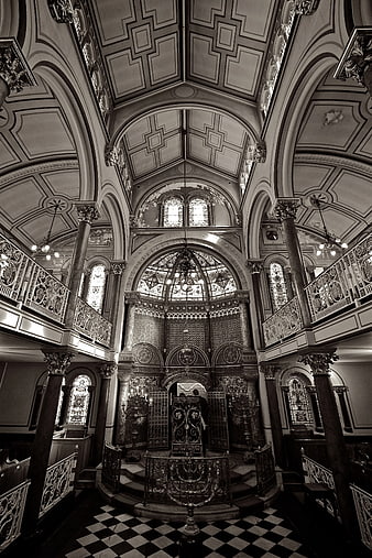 Black and white interior of ornate synagogue with checkered floor