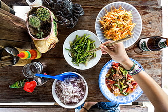 Top view of Vietnamese meal with rice, stir-fry, and papaya salad