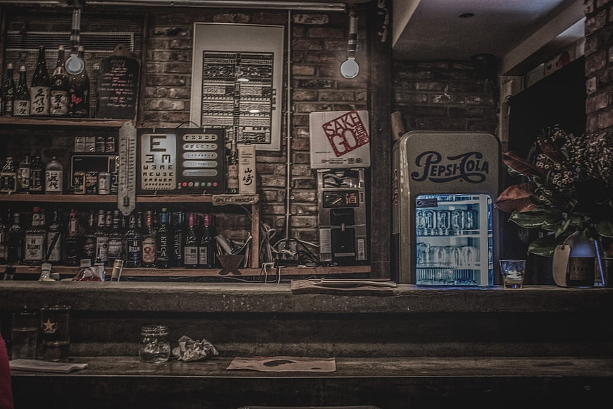 Vintage Japanese Bar Interior with Sake Bottles and Pepsi Fridge