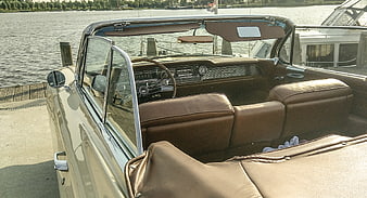 Vintage beige convertible car interior parked by the water