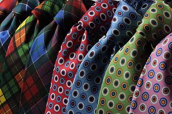 Colorful patterned neckties arranged in a row closeup