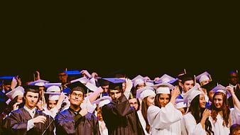 Diverse Graduates Throwing Caps in Celebration
