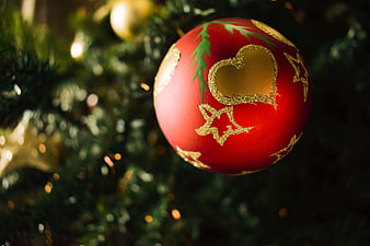 Red Christmas Ornament With Gold Heart Detail On Tree