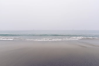 Foggy Beach Landscape with Gentle Ocean Waves