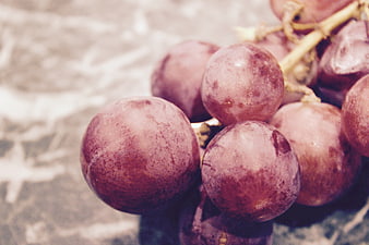 Close-up of fresh red grapes on rustic background