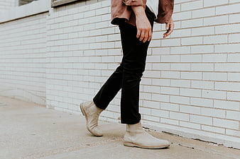 Man Walking in White Chelsea Boots and Black Pants