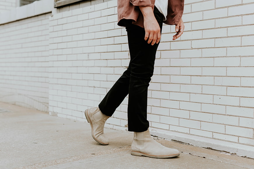 Man Walking in White Chelsea Boots and Black Pants
