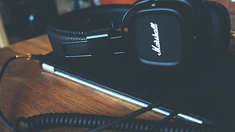 Black Marshall Headphones on Laptop with Coiled Cable