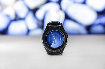 Black Smartwatch with Blue Dial on White Surface