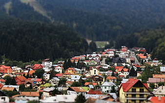 Tilt-shift village nestled in green mountain valley