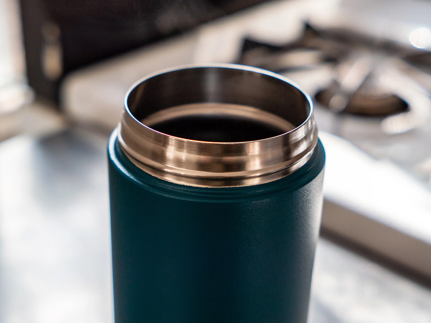 Close-up of teal stainless steel coffee tumbler
