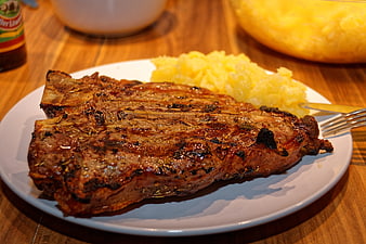 Grilled T-Bone Steak With Potato Salad On White Plate