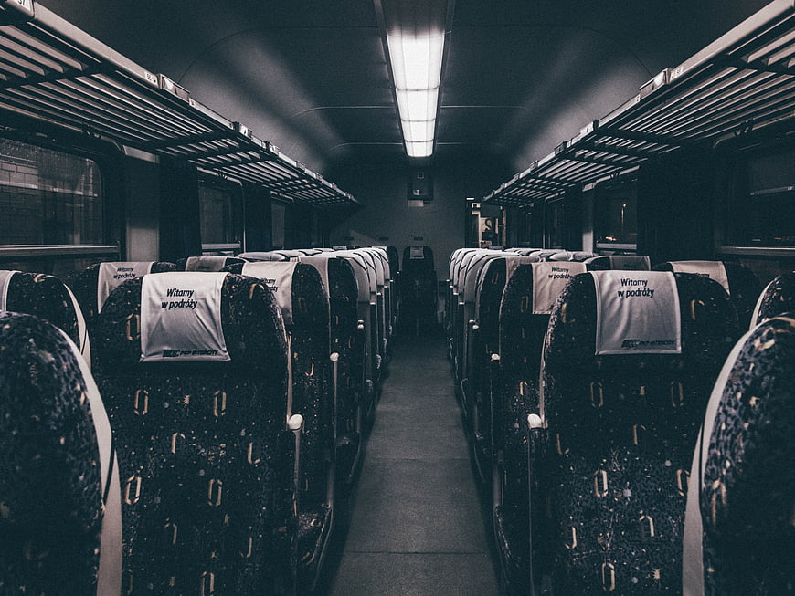 Empty Train Carriage Interior with Aisle and Seats