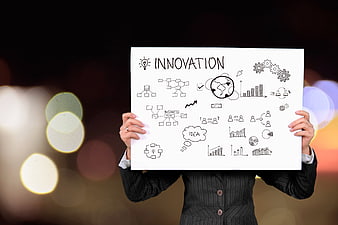 Businesswoman holding innovation concept board with charts