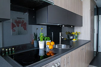 Modern kitchenette with black countertop and fresh fruit