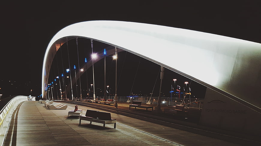 Modern illuminated bridge architecture at night with benches