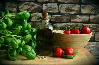 Fresh Basil, Olive Oil, and Tomatoes on Wooden Board