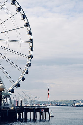 Seattle Great Wheel and Pier with American Flag on Overcast Day