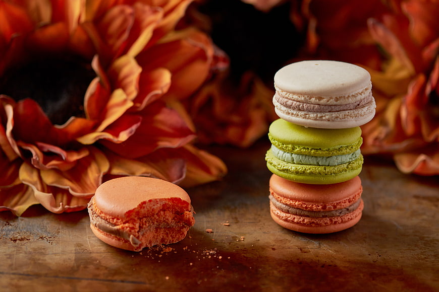 Stacked colorful macarons with autumn sunflower background