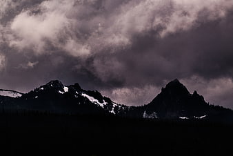 Dramatic Dark Mountain Peaks Under Stormy Clouds