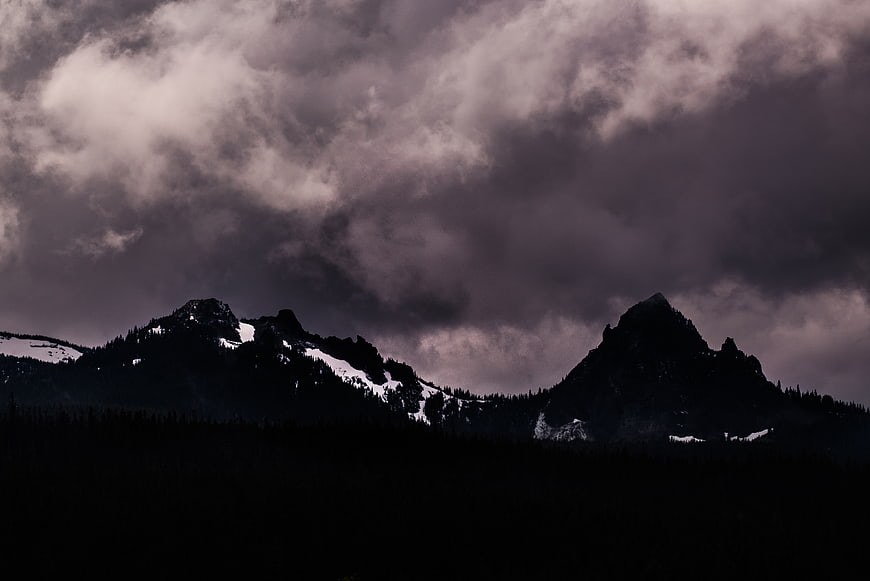 Dramatic Dark Mountain Peaks Under Stormy Clouds