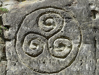Ancient Triskele Spiral Carved in Weathered Stone Rock