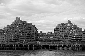 Black and white waterfront apartment buildings with pier