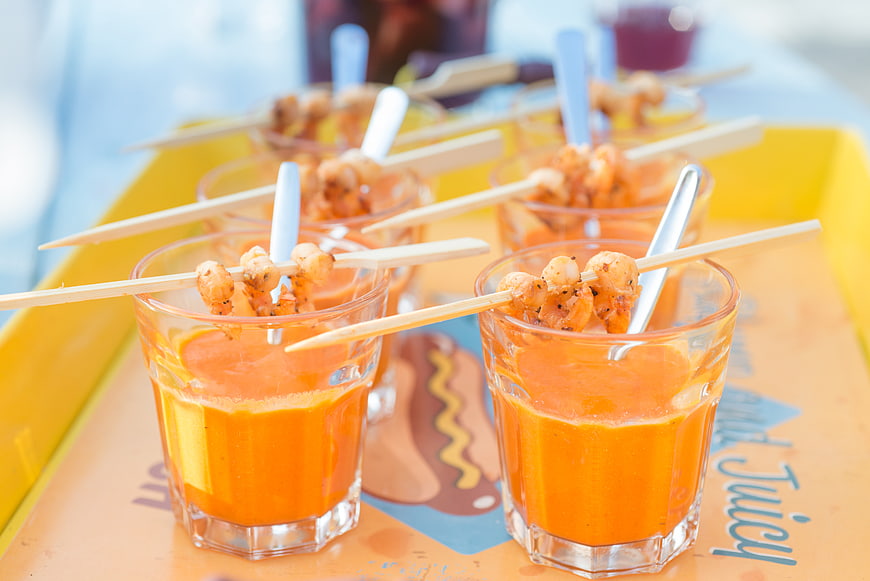 Shrimp cocktail appetizers in glasses on a yellow tray