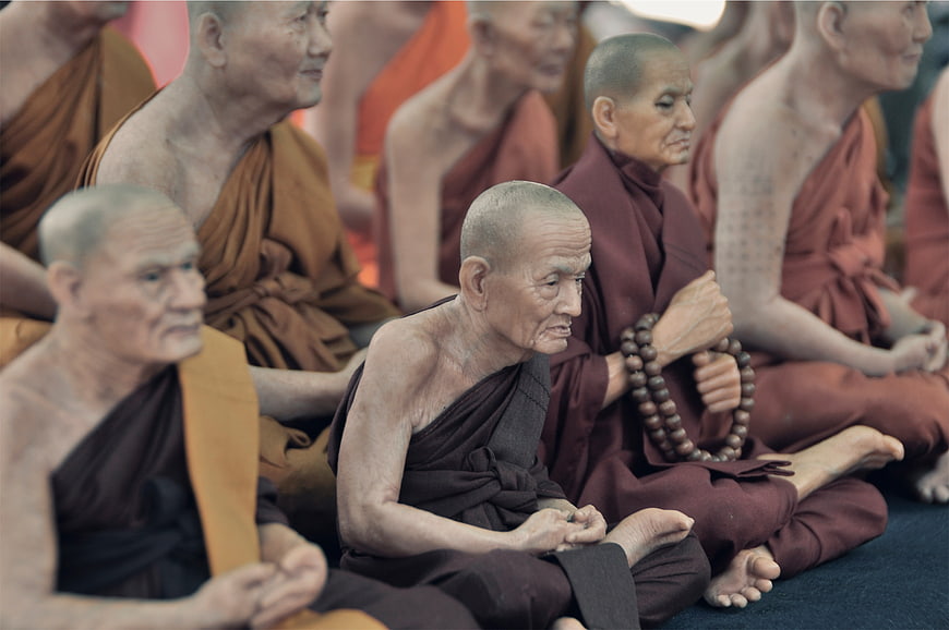 Elderly Buddhist Monks Meditating in Traditional Robes