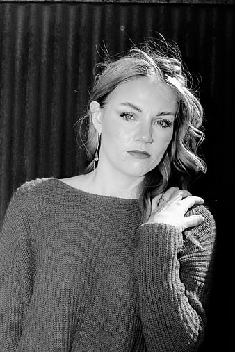 Black and white portrait of a woman in a knit sweater
