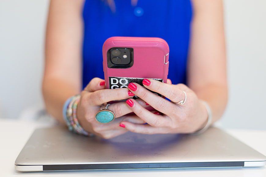 Woman Hands Holding Smartphone with Pink Case