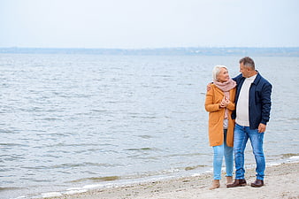 Senior couple embracing on a beach by the sea