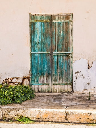 Weathered Blue Wooden Door on Old Wall