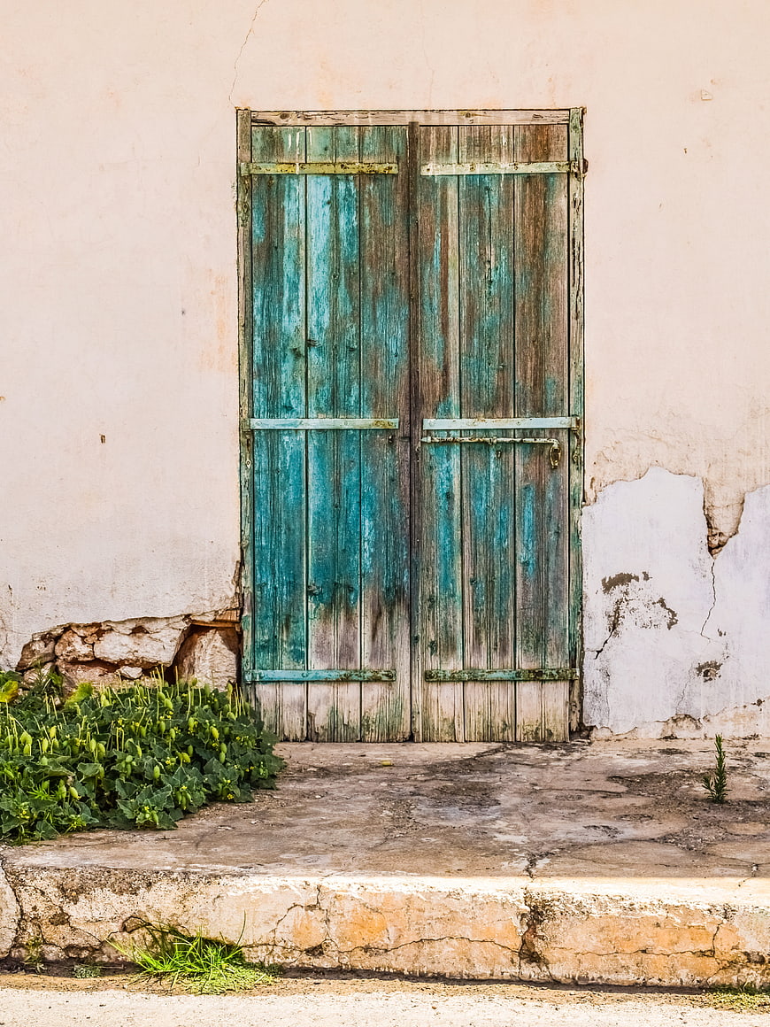 Weathered Blue Wooden Door on Old Wall