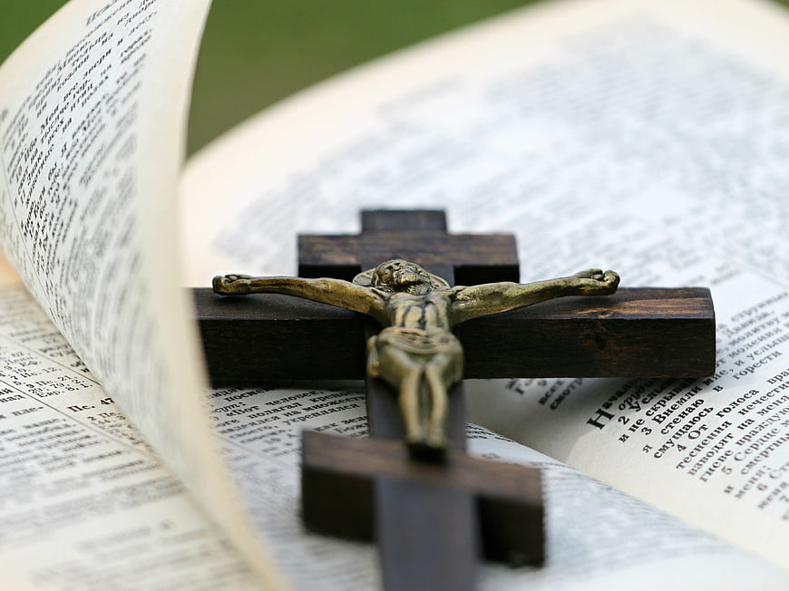 Wooden Crucifix on Open Bible Pages
