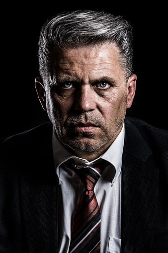 Serious mature businessman portrait in suit and tie