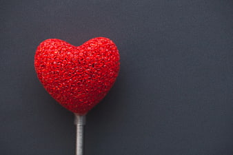 Red Glitter Heart Lollipop on Dark Background