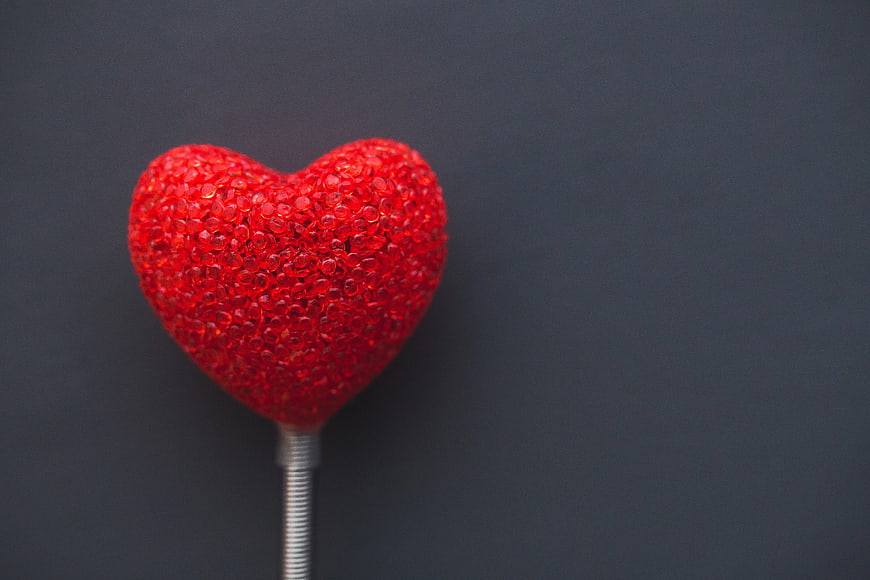 Red Glitter Heart Lollipop on Dark Background