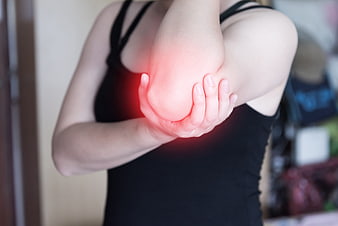 Woman holding elbow with red pain glow effect